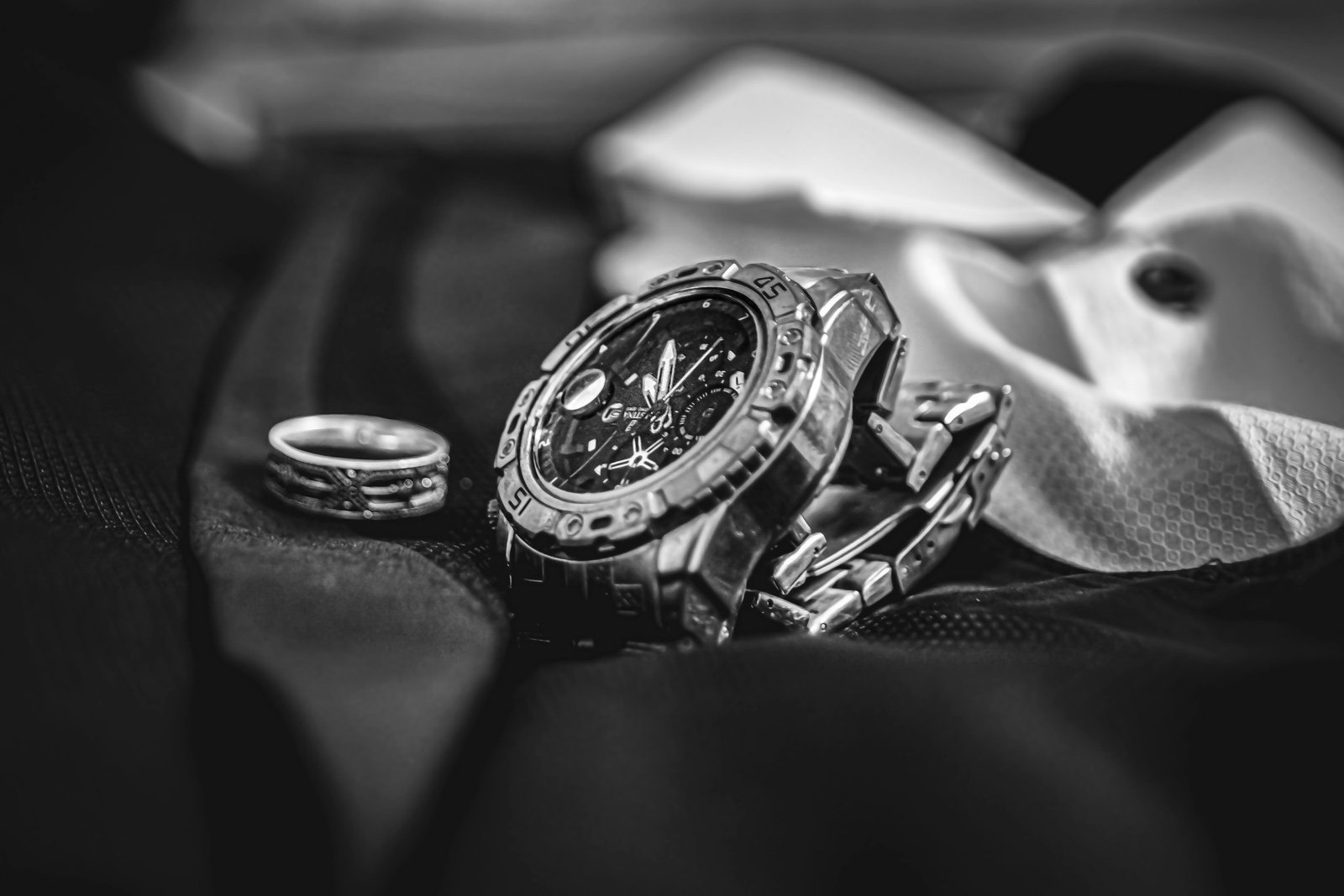 Groom's ring and watch, black and white detail